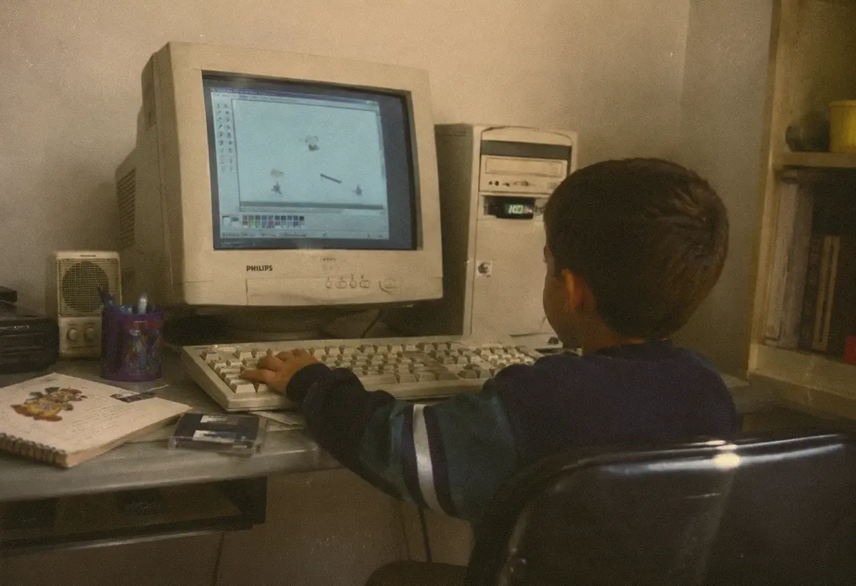 A young Ignacio Soler sitting at a Philips CRT computer, drawing on screen.